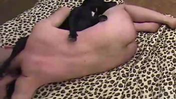 Bald man and aroused ebony canine are indulging in explicit homemade animal encounters