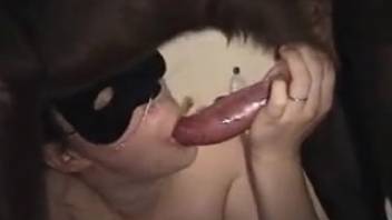 Disguised beauty displays her oral sex skills in an animal park clip