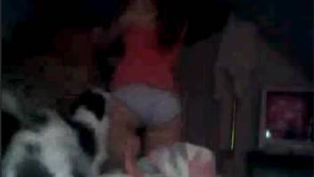 Attractive young woman with a moist vagina allows a canine to lap at her