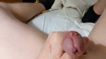 Aroused homosexual man jerks off using a large worm inside his penis